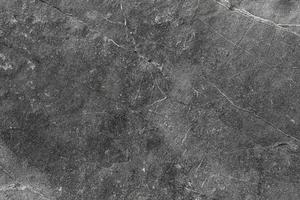 Background and textured surface of above view stone. Dark spots and natural patterns. photo