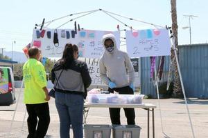 LOS ANGELES  APR 11 - Masks for sale table in empty parking lot at the Businesses reacting to COVID 19 at the Hospitality Lane on April 11, 2020 in San Bernardino, CA photo