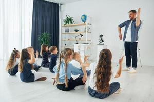 Learning gesture language. Group of children students in class at school with teacher photo