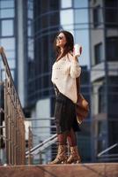 Can take some walk after work. Young beautiful girl in warm clothes in the city at her weekends time photo