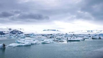 Tabular icebergs melt at turquoise ocean bay. Huge high ice glacier at polar nature environment. Arctic winter landscape at global warming problem. Desert white land of snow and ice timelapse. video