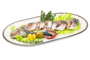 Mackerel fish, sliced on a plate with lettuce photo