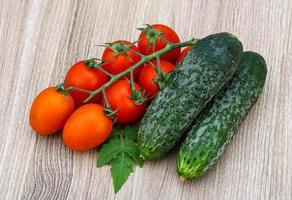 Cucumbers and tomatoes on the branch photo