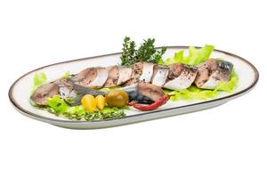 Mackerel fish, sliced on a plate with lettuce photo