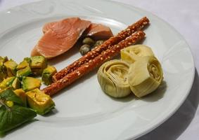 Salmon with avocado and artichoke photo