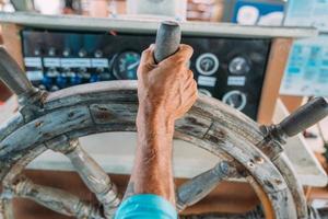 Sailing sport. focus on Steering compass and capitain hand photo