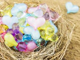 Small colorful decoration heart in a bird nest photo