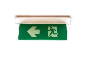 Isolated ceiling emergency exit sign in the building photo