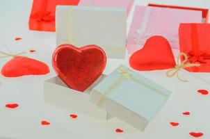 Red heart shape chocolates with present boxes. photo