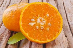 Oranges on wooden background photo