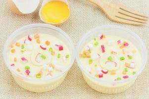 Thai steamed egg with fresh beaten egg and fork decoration on sack background photo