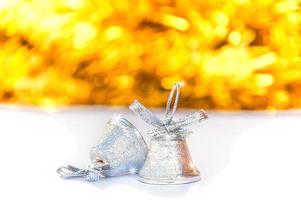 Silver bells with blur shiny yellow stripe and white background, Christmas decoration object photo