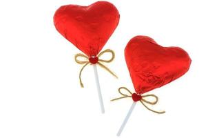 Couple of red heart chocolate isolated over white background photo