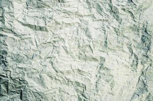 Green tone crumpled paper abstract background photo