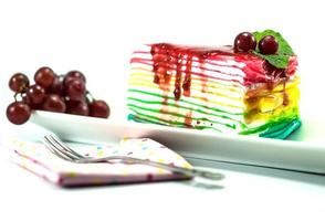 Rainbow crepe cake on white background photo