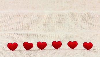 Small red hearts putting on sack for background use photo