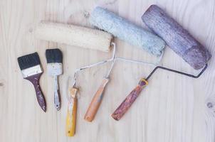 Old painter brush set, hand tool, over white wooden background photo