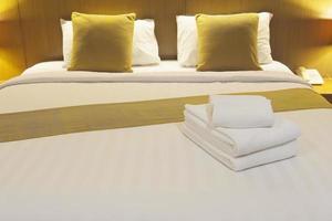 White bedding and towel set in modern hotel photo