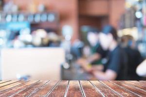 Wooden shelf over blurred coffee shop background photo