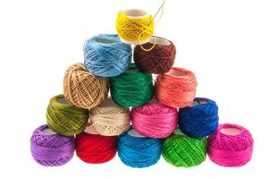 Stack of yarn balls over white background photo