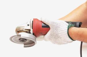 Worker is using angle grinder, hand tool, isolated over white photo