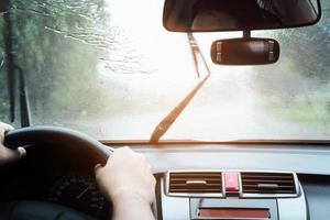 Man driving car in heavy rainfall photo