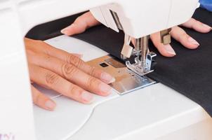 Woman's hands, doing her patchwork using sewing machine photo