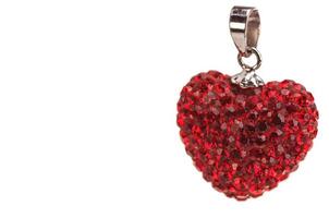 Red heart ornament isolated over white background. Photo is focused only at front surface of the object.