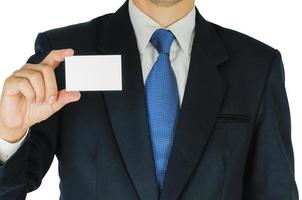 Businessman is holding or showing blank white card isolated over white background. Photo is focused at his hand and included clipping path of white background.