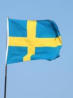 Swedish flag flying on flagpole photo