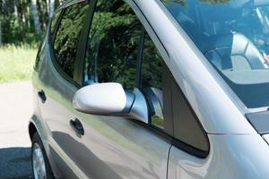 side view of a exterior of metallic car and its rear view mirror. travelling and car jorney concept photo