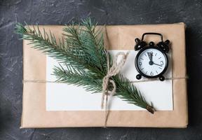 minimal style christmas wrapping of gifts. paper present decor. eco gifts with natural fir tree decoration on grey background photo