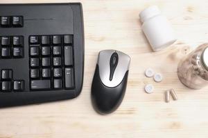 keyboard, mouse and bottles of mental support supplement photo