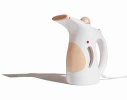 compact electric garment steamer on white background. fabric steamer isolated with shadow. housekeeping routine tools.