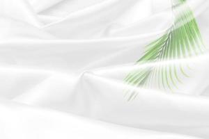 green palm leaves pattern overlay with white fabric texture soft blur background photo