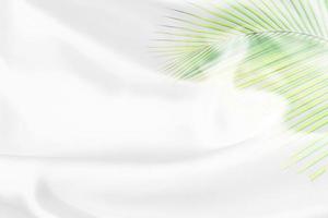 green palm leaves pattern overlay with white fabric texture soft blur background