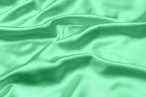 green satin fabric texture soft blur background photo