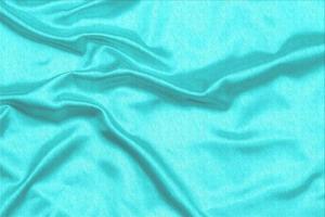 Cyan-Teal satin fabric texture soft blur with palm leaves pattern background photo