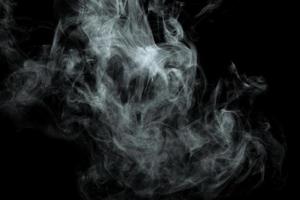 Abstract powder or smoke isolated on black background photo