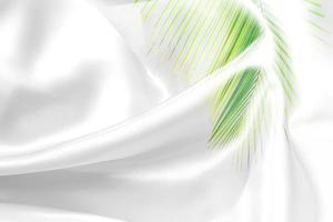 green palm leaves pattern overlay with white fabric texture soft blur background photo