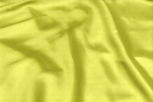 Yellow satin fabric texture soft blur with palm leaves pattern background photo