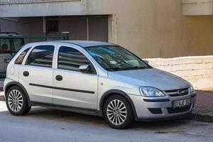 Antalya Turkey  March 04 2022 silver Opel Corsa is parked  on the street on a warm day photo