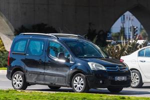 Antalya Turkey  March 04 2022 black Berlingo Multispace  is  driving   on the street on a warm  autumn  day photo