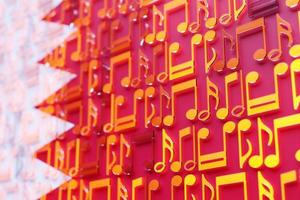 Musical notes lined up in even rows against the backdrop of the National Flag of Bahrain.  The concept of the national anthem, music photo