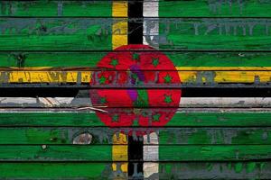 The national flag of Dominica is painted on uneven boards. Country symbol. photo