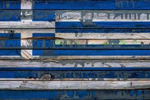 The national flag of Greece is painted on uneven boards. Country symbol. photo