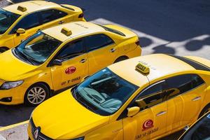 Antalya Turkey March 04 2022  Parking of yellow taxi cars on the background of a city street photo