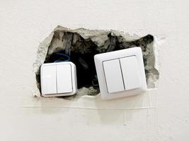 electrical switch and repair. installation of the switch. hole in the wall. photo