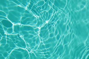 Defocus blurred water in swimming pool rippled water detail background photo