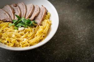 dried duck noodles in white bowl photo